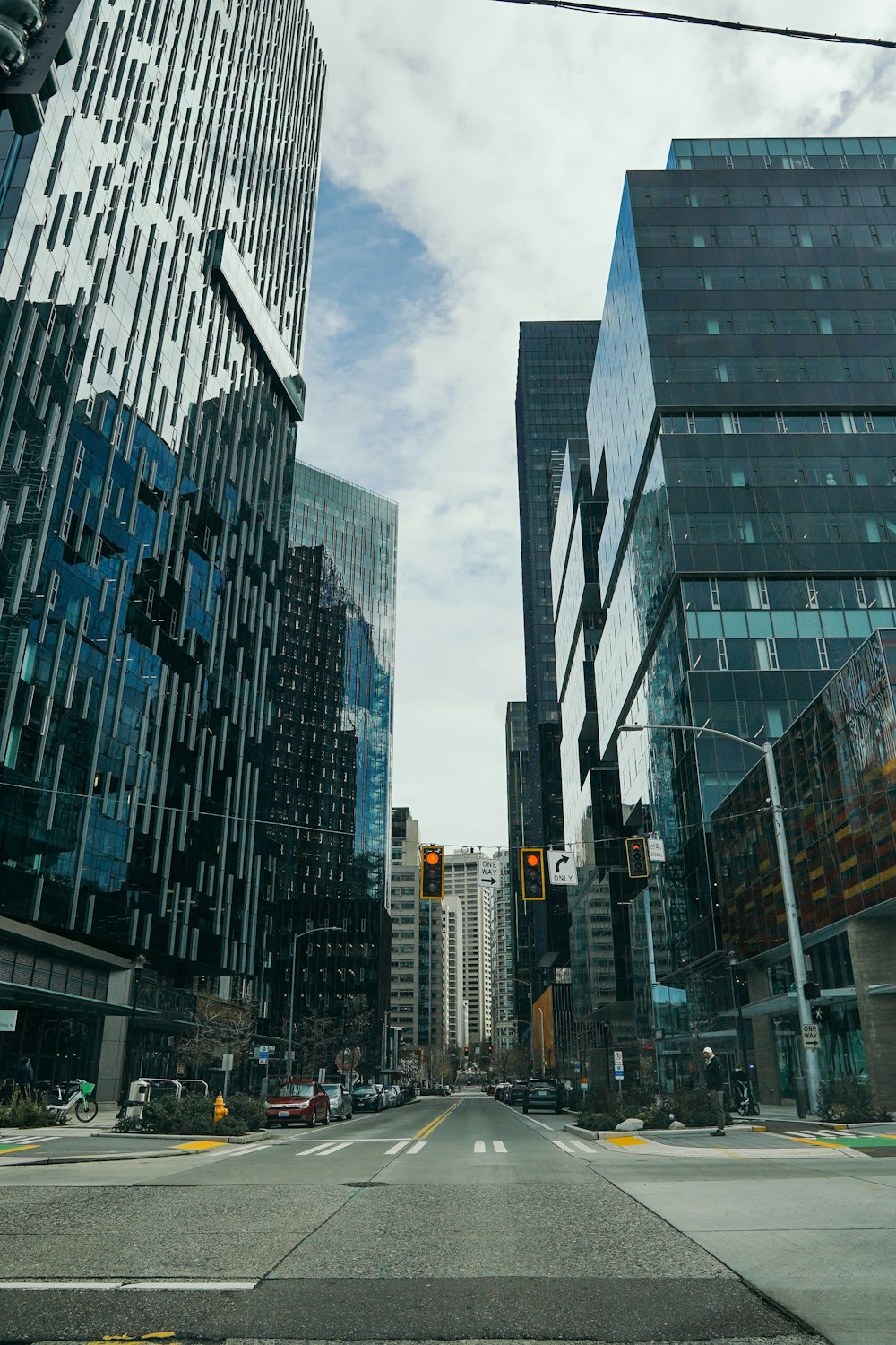 a city street with tall buildings and a traffic light