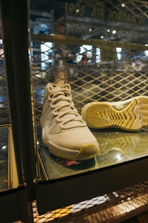 Sneakers displayed on a shelf with soft natural light, emphasizing texture and color.