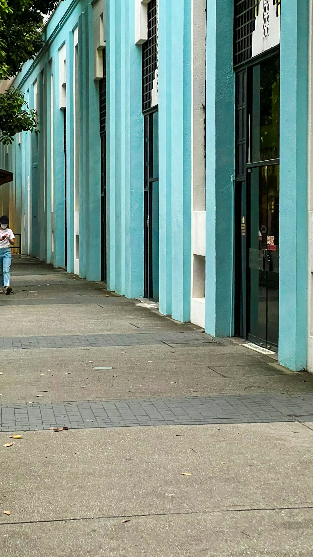 a man riding a skateboard down a sidewalk