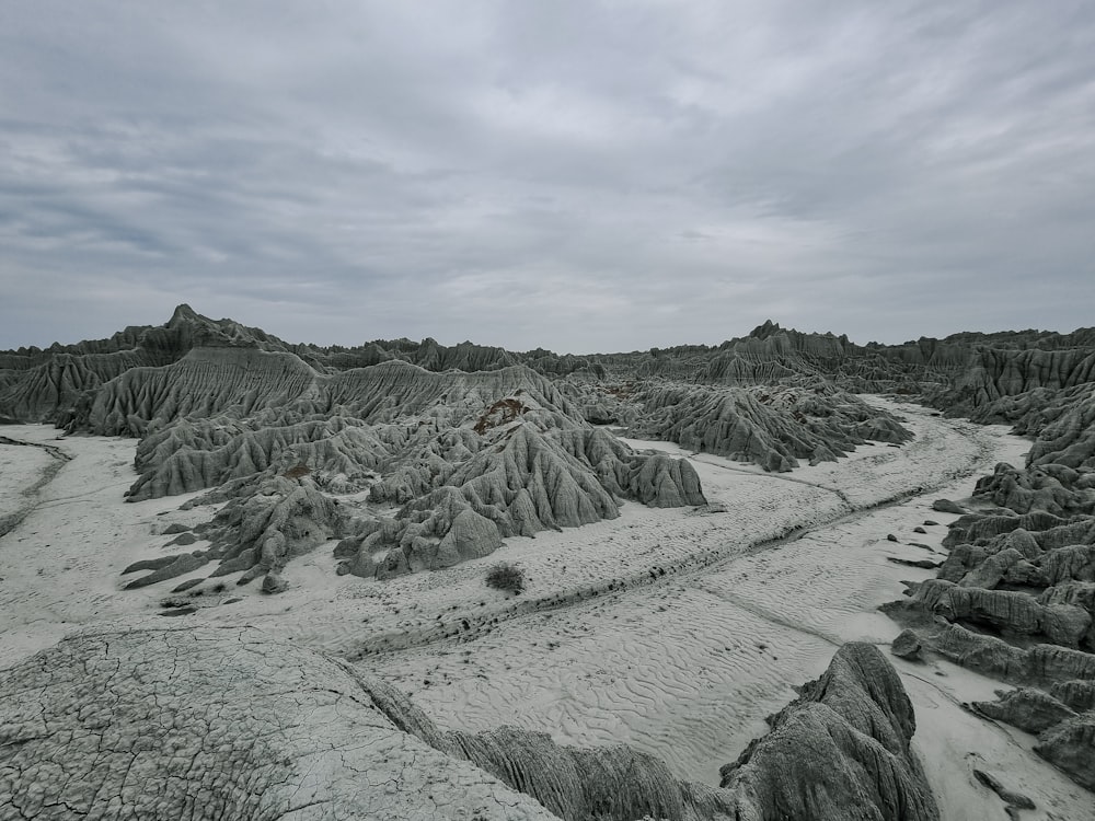 an aerial view of a desert landscape with rocks and sand