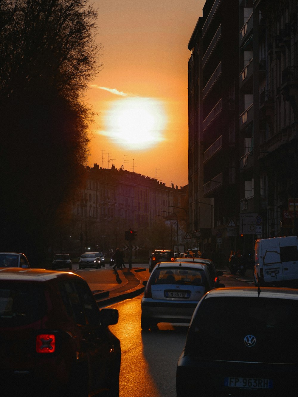 a city street filled with lots of traffic at sunset