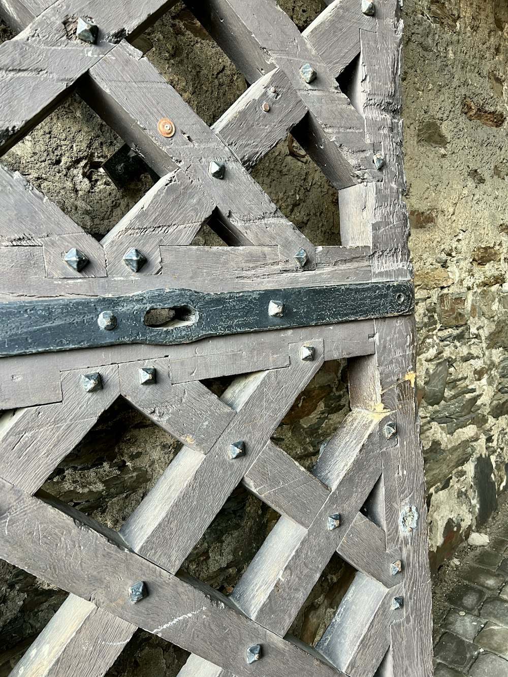 a close up of a piece of wood with rivets