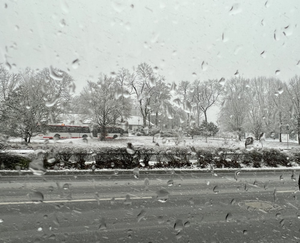 a view of a snowy street from a car window