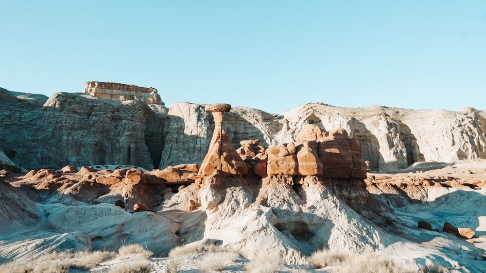 a rocky landscape with a mountain in the background