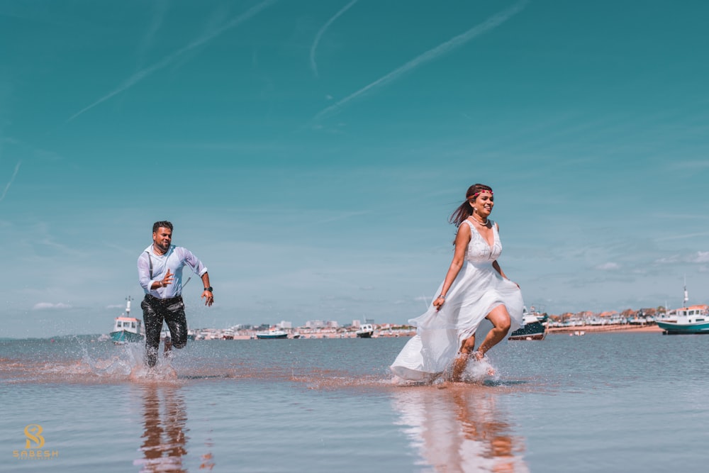 a man and a woman are running in the water