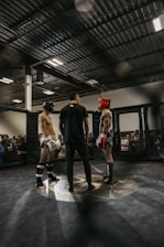 a couple of people standing in a boxing ring