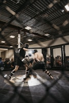 An intense clash between two fighters surrounded by neon graffiti and pulsing lights.