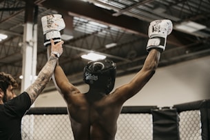 a couple of men standing next to each other in a gym