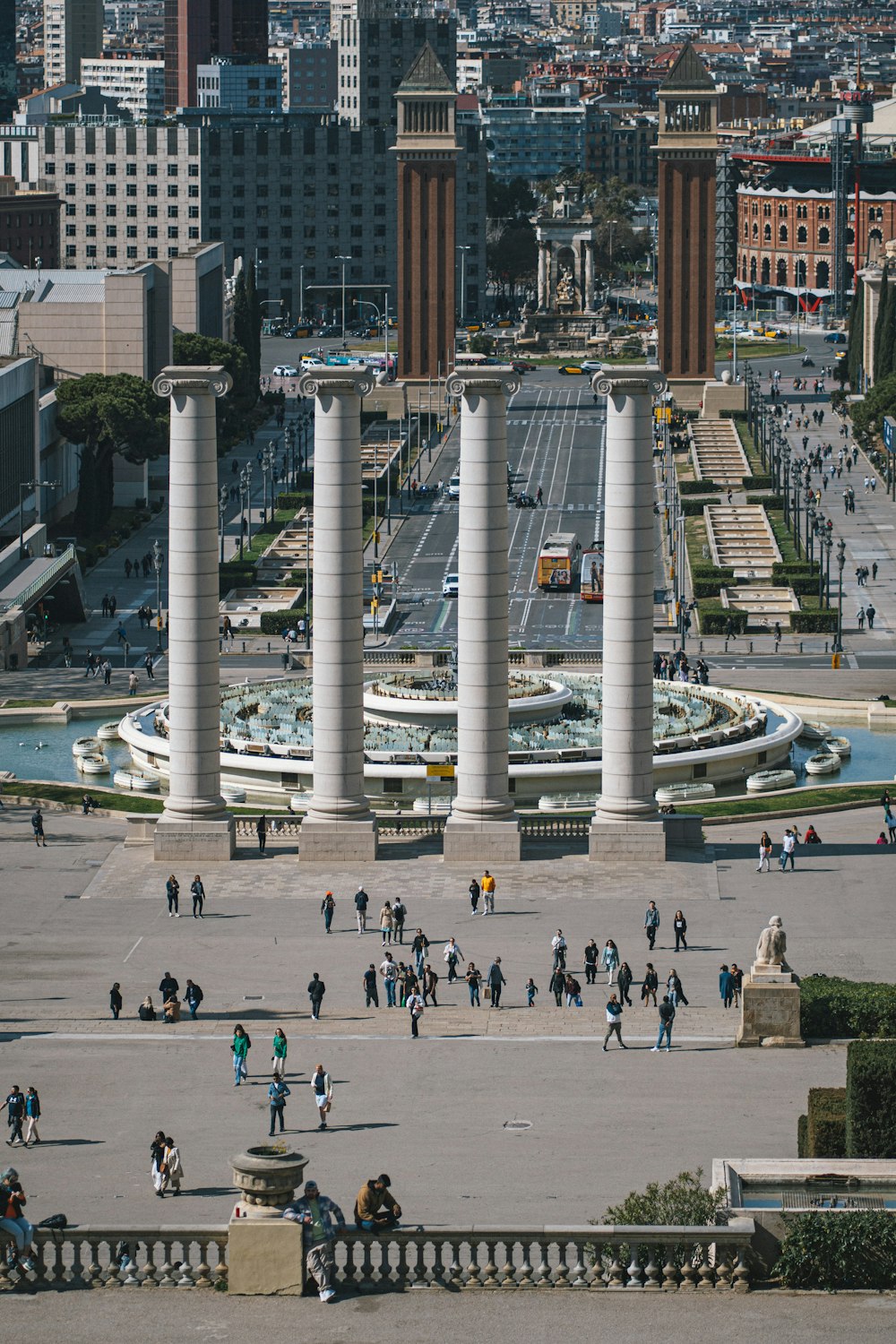 a group of people walking around a city square