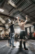 a couple of men standing on top of a wrestling ring