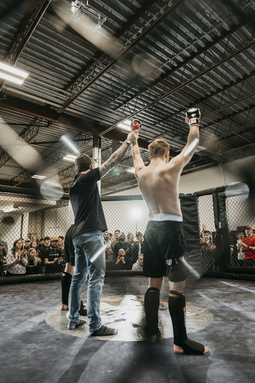 a couple of men standing on top of a wrestling ring