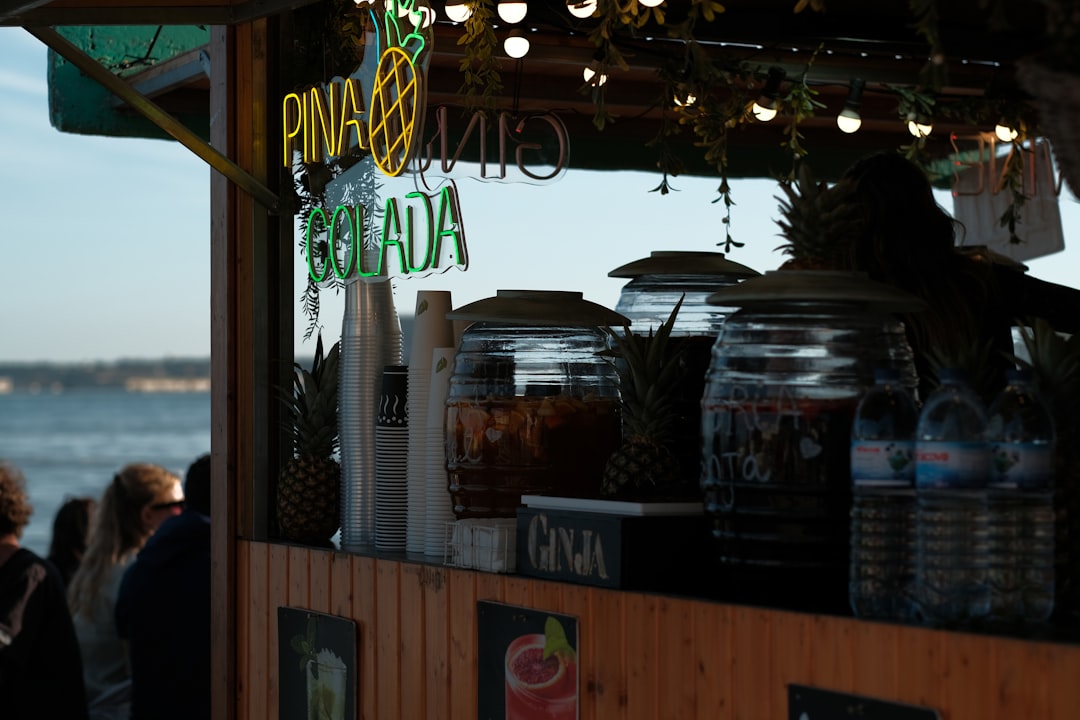 a group of people standing around a food stand,
