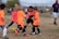 A group of children practicing soccer drills under the guidance of a coach.