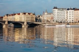 A scenic riverbank lined with charming buildings and boats.