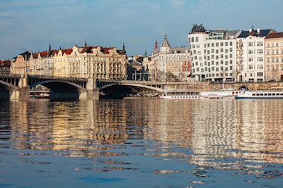A scenic riverbank lined with charming buildings and boats.