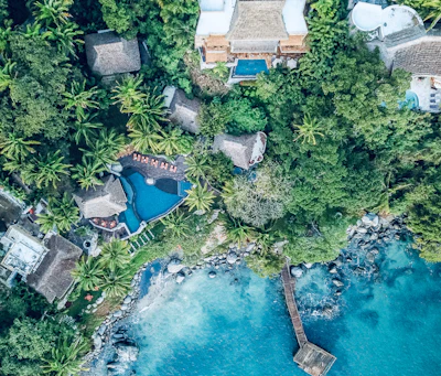 Sayulita from the air, pools and roofs among the jungle above the bay