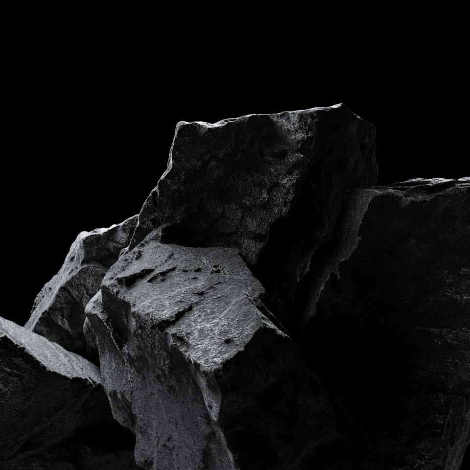 Dark gray rocks stacked in haphazard manner against stark black background showcasing rock textures