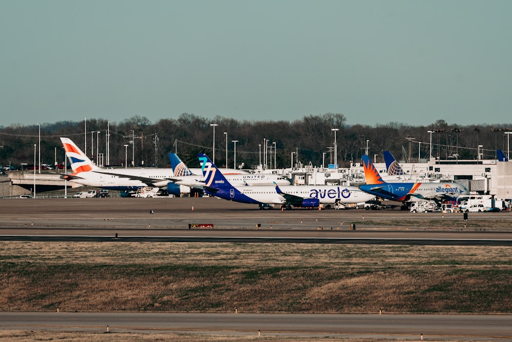 several airplanes are parked on the runway at an airport