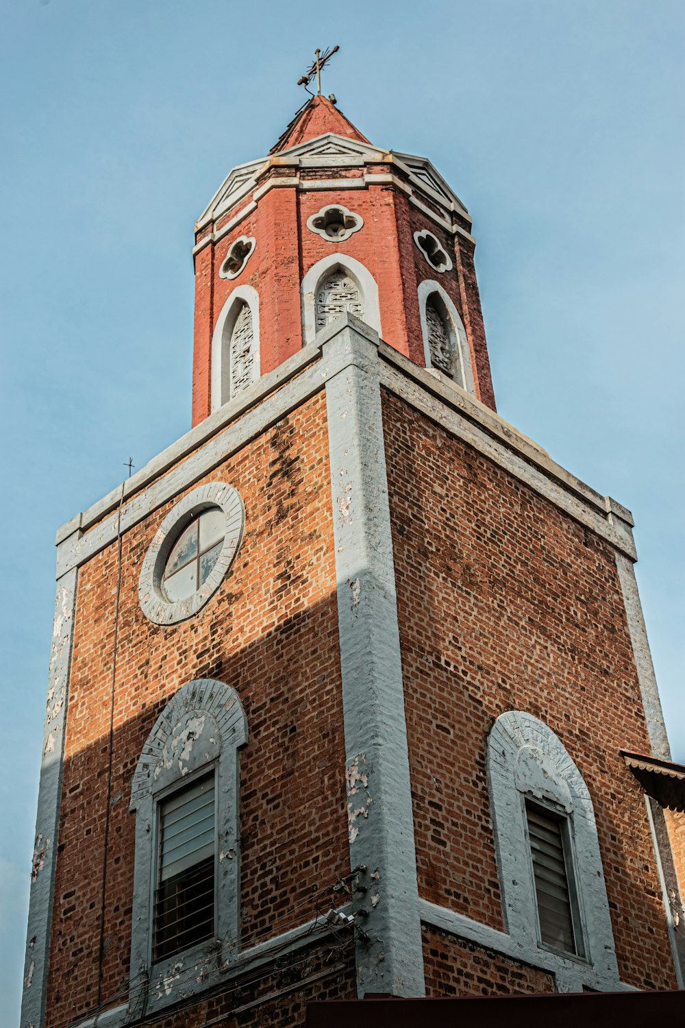 a tall brick building with a clock on it's side