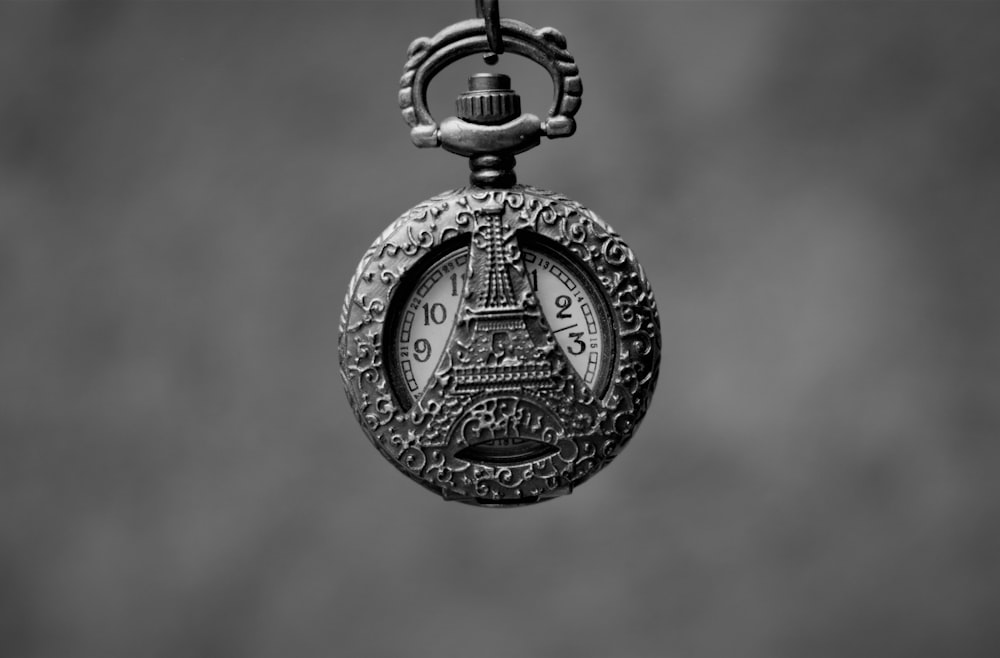 a black and white photo of a pocket watch