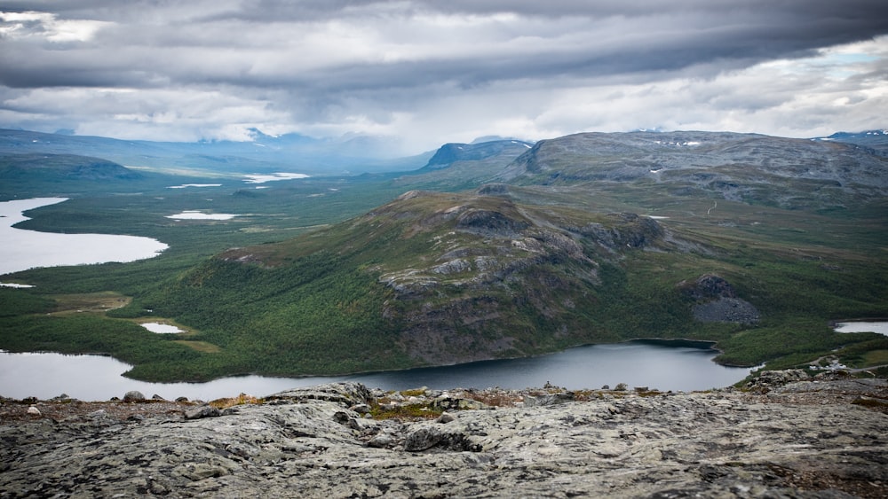 a view of a mountain range with a lake in the foreground