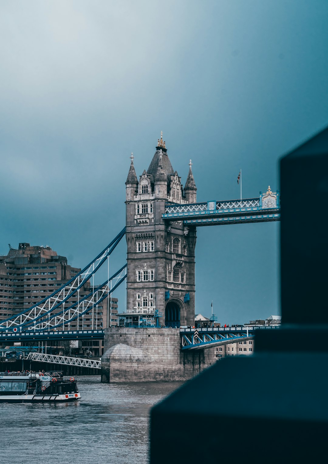 Tower Bridge in London, UK, with cloudy sky background.