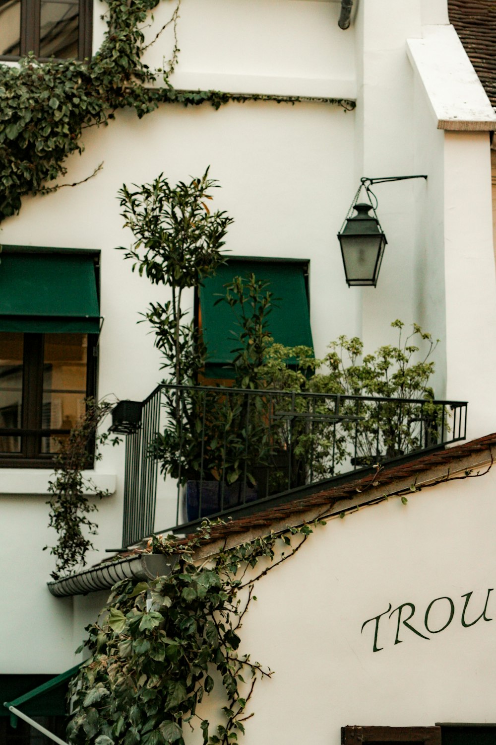 a white building with a green door and window