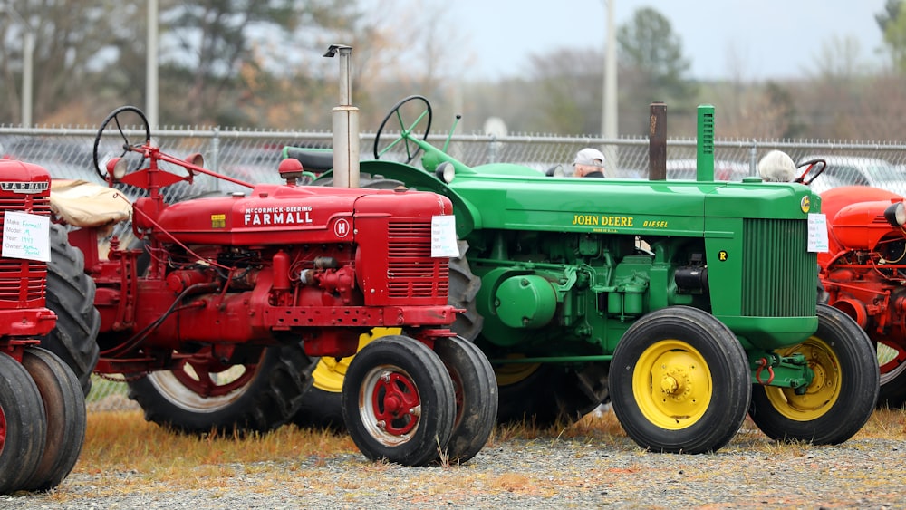 a row of red and green farm tractors