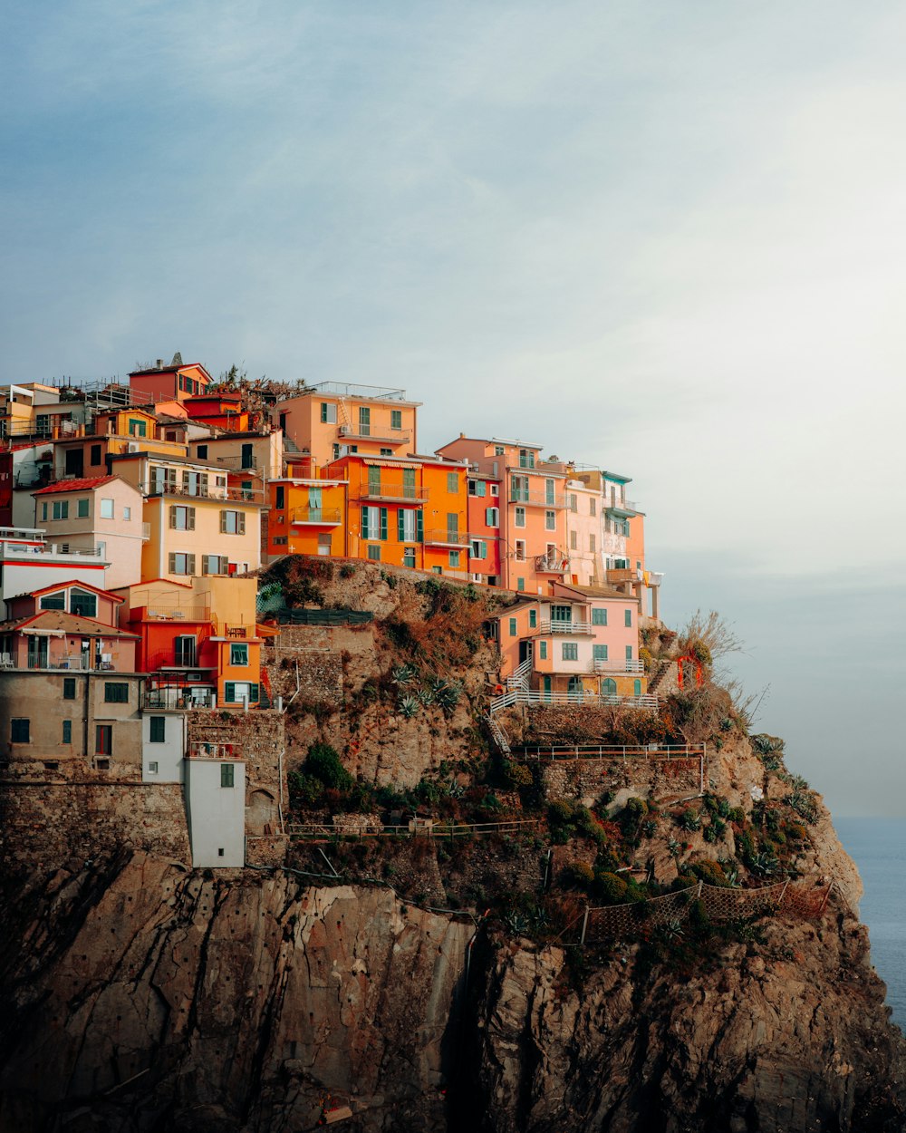 a small village on top of a cliff by the ocean