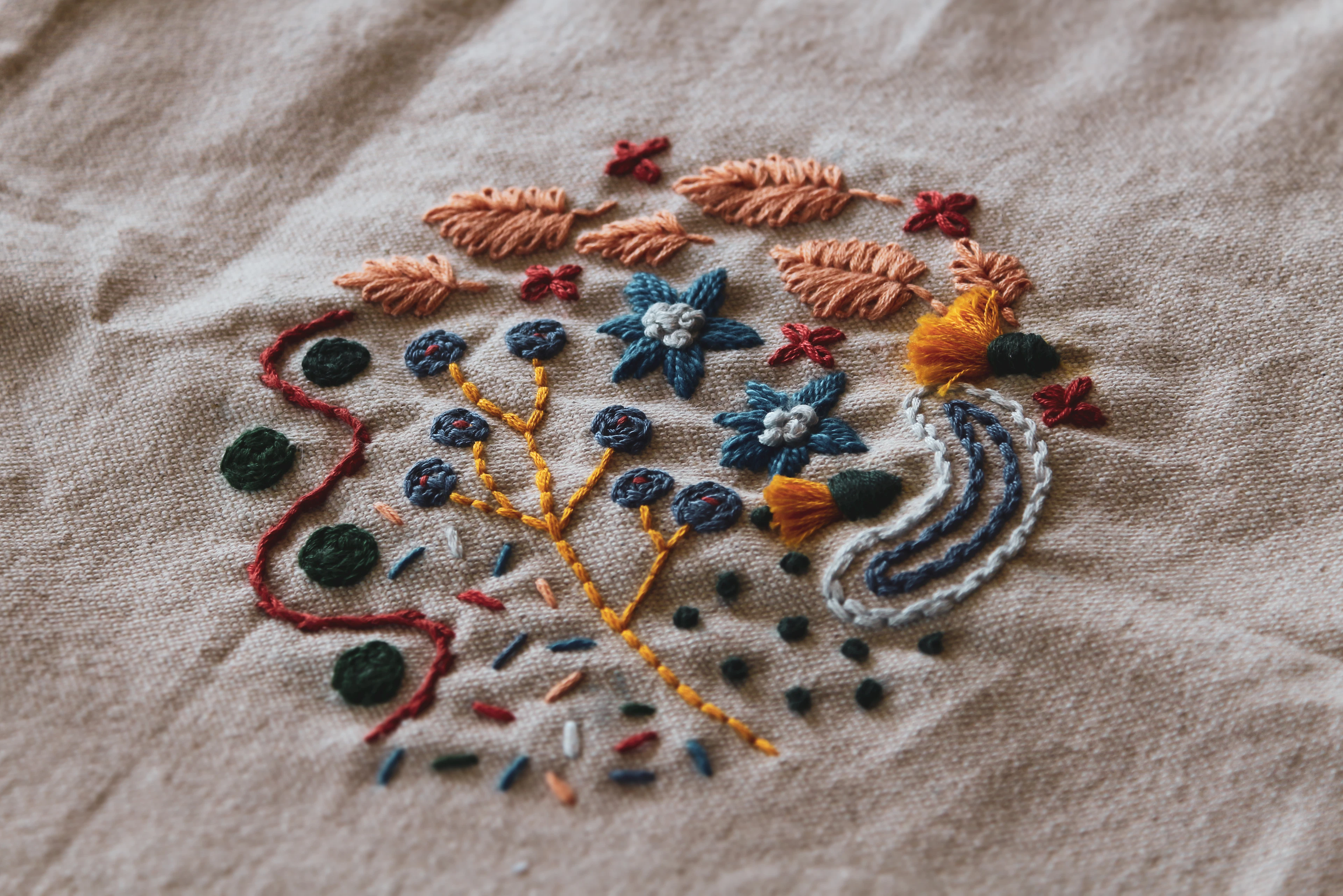 Close-up of colourful hand embroidery on fabric