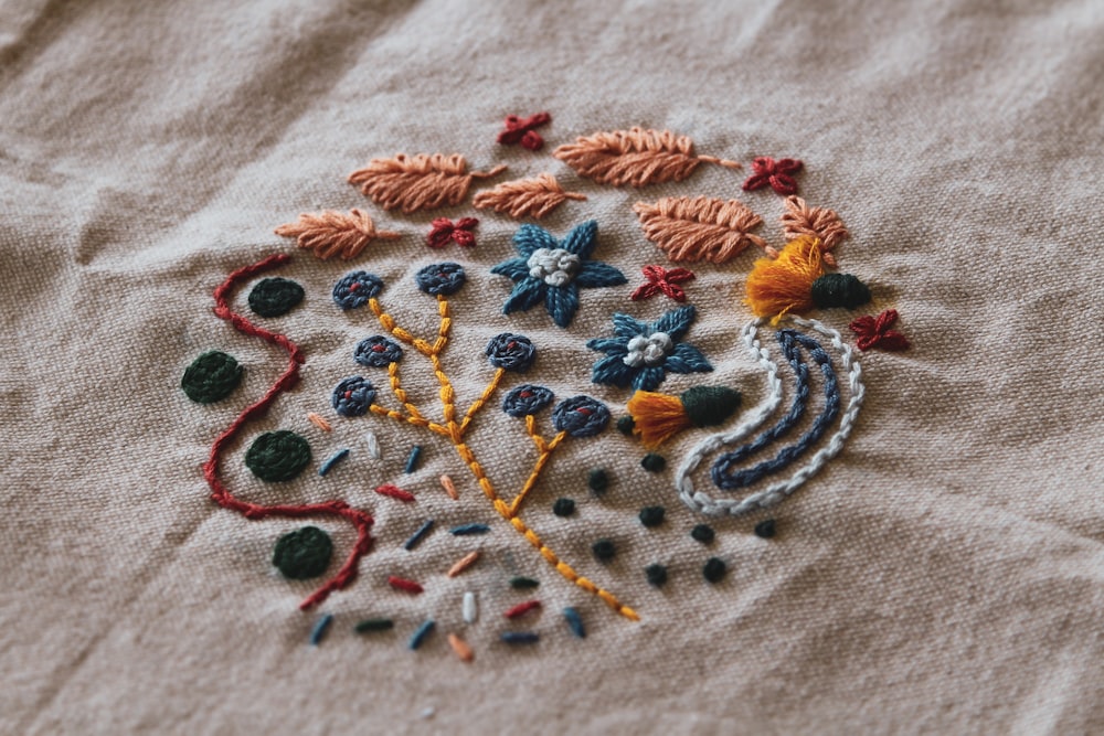 a close up of a embroidered object on a cloth