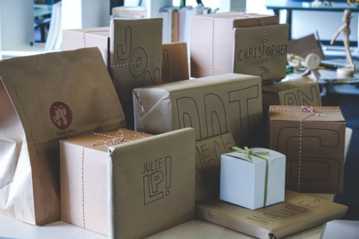 a pile of brown paper bags sitting on top of a table
