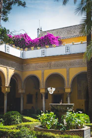 An impeccably maintained Colombian villa courtyard bathed in warm afternoon light.