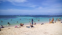 a beach filled with lots of people on top of it