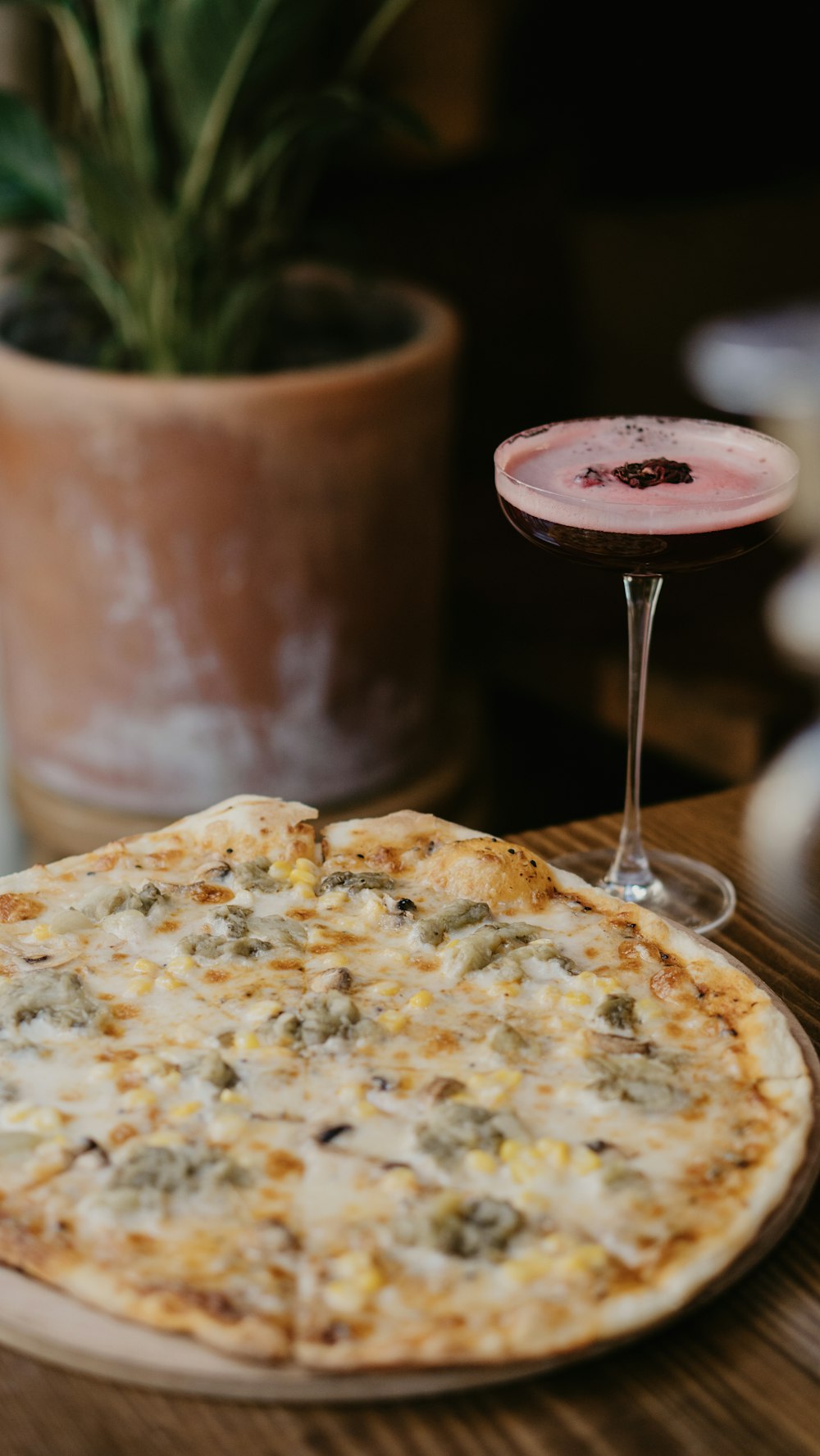 a pizza and a drink on a table