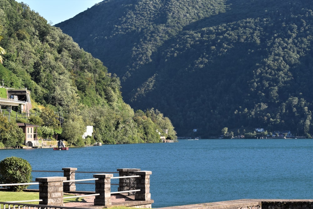 a large body of water surrounded by a lush green hillside