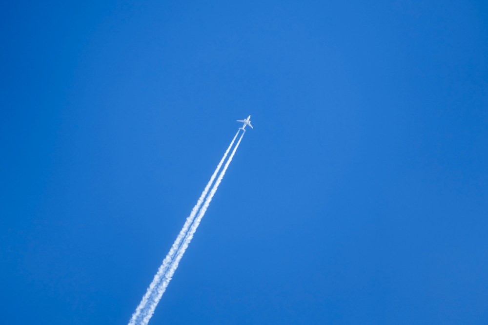 an airplane is flying high in the sky