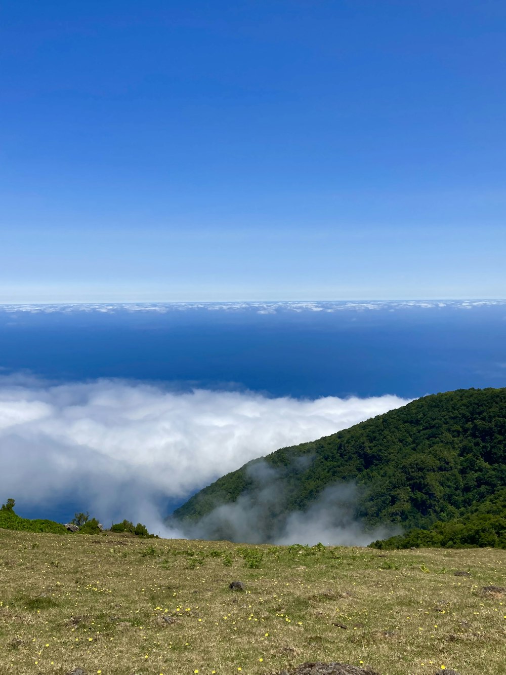 a view of a mountain with clouds in the sky