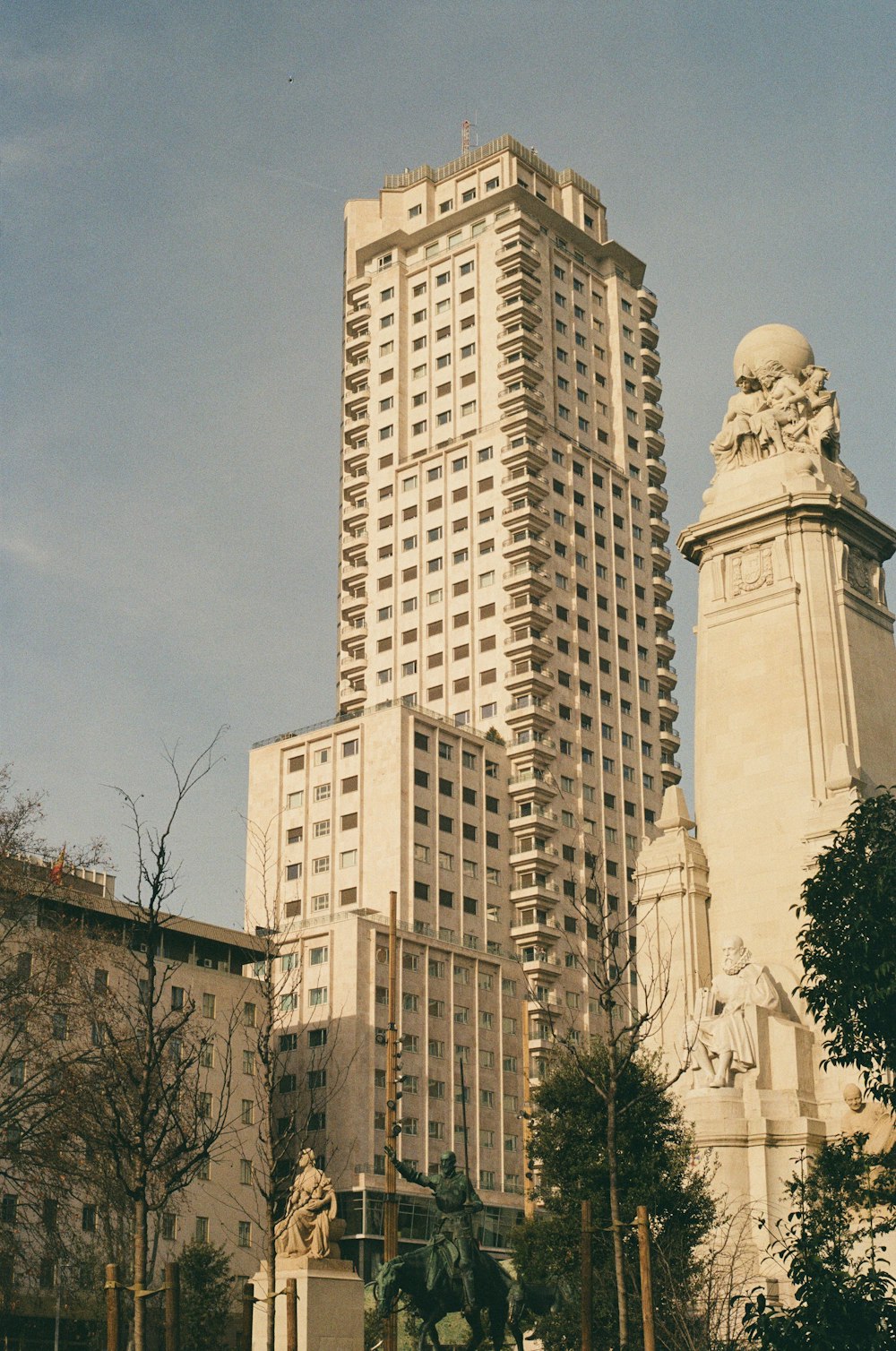 a tall building with a statue in front of it