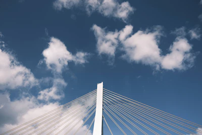 A detailed blueprint of a cable-stayed bridge with AI annotations overlay.