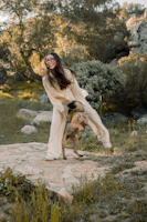 A joyful dog and trainer sharing a playful moment outdoors during a training session.