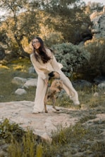 A cozy scene of a pet owner playing with a dog in a sunny park.