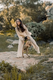 A friendly trainer guiding a joyful dog during an outdoor training session.