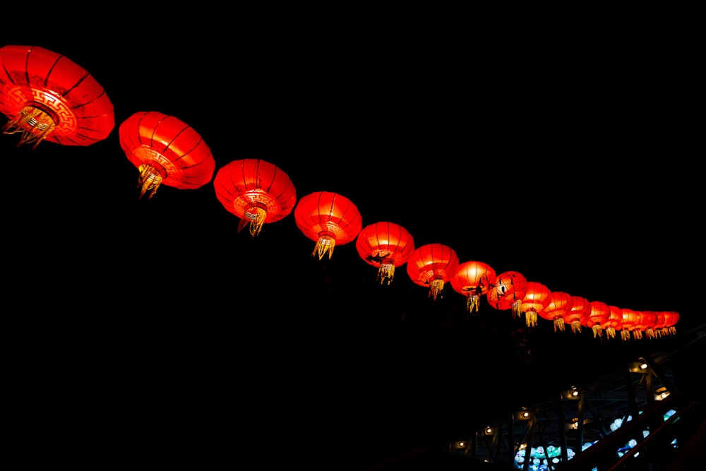 a long line of red lanterns in the dark
