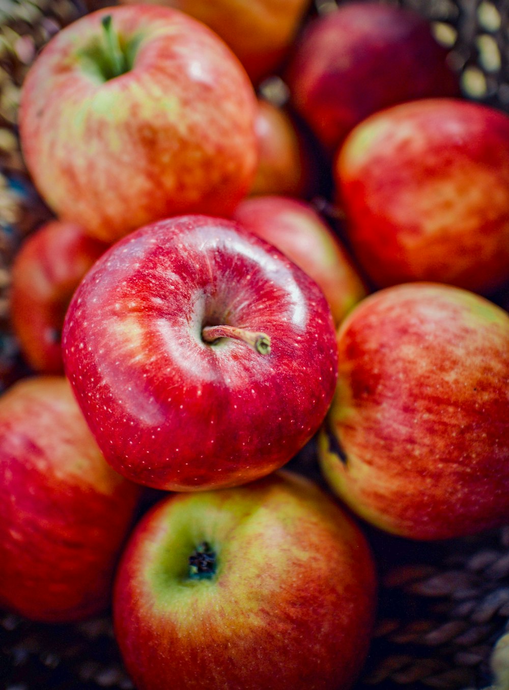 a basket filled with lots of red apples