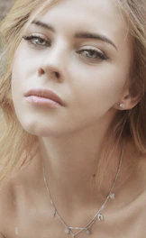 a woman with a necklace on her neck