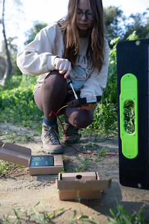 a woman kneeling down in front of a box