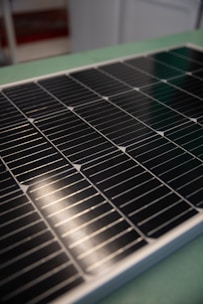 A sleek close-up of a high-efficiency solar panel glistening under sunlight on a modern rooftop.