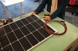 a person working on a solar panel on a table