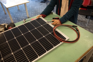 a person working on a solar panel on a table